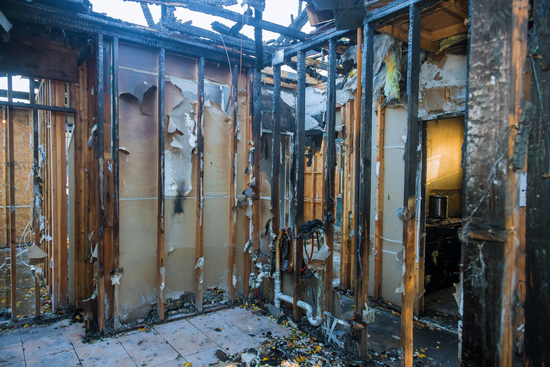 Burnt wooden walls house with charred roof burnt